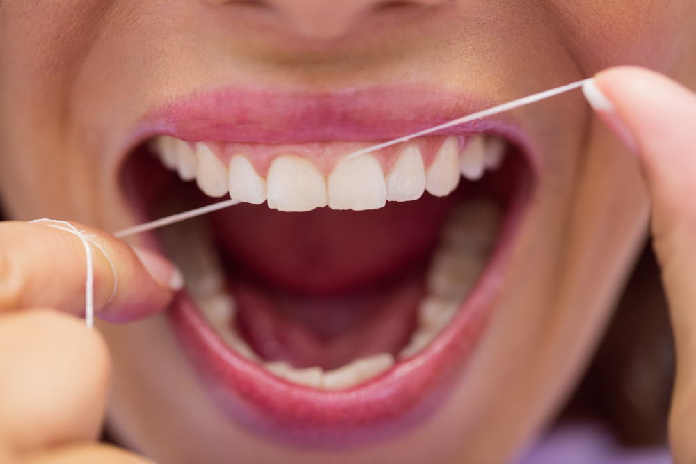 Person flossing their teeth